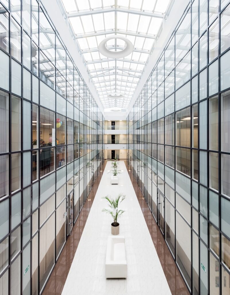 Two business professionals reviewing financial documents and graphs during a meeting.