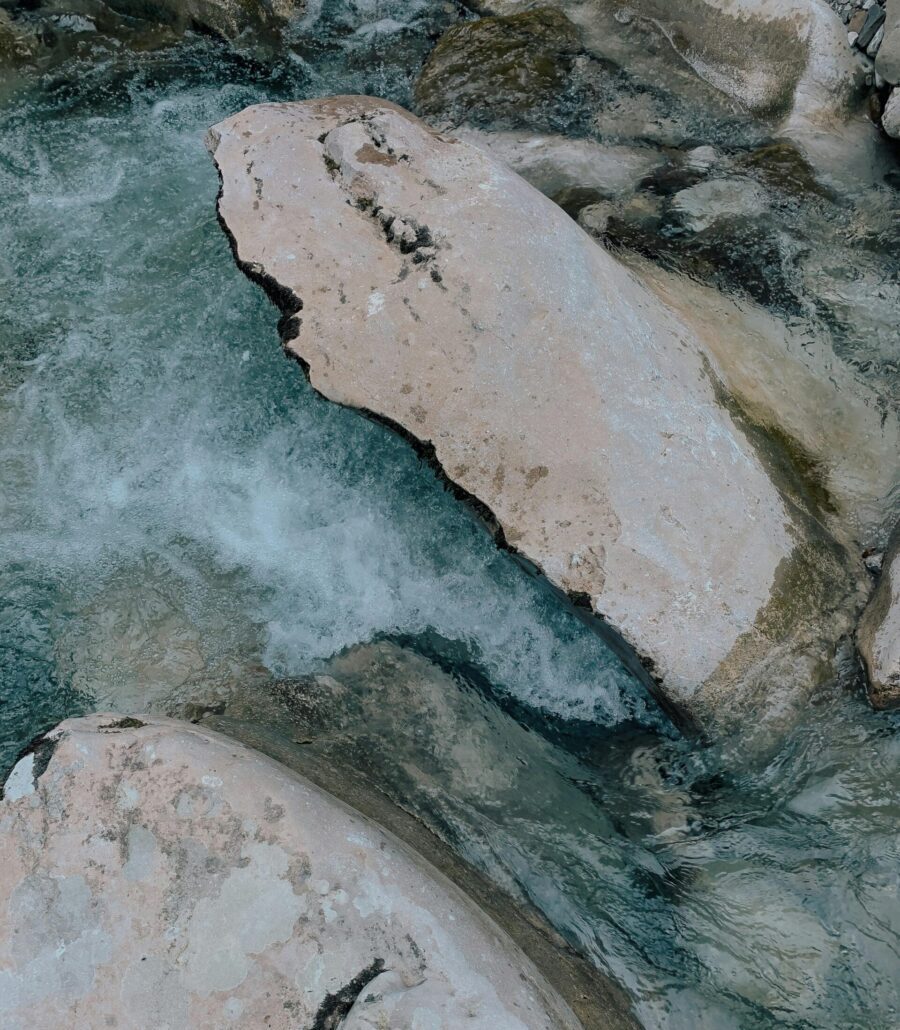 A businessman with glasses reviewing data on a tablet in an office setting.